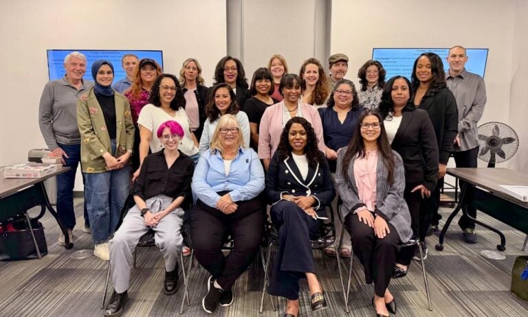 Group of diverse women and men in a conference room.