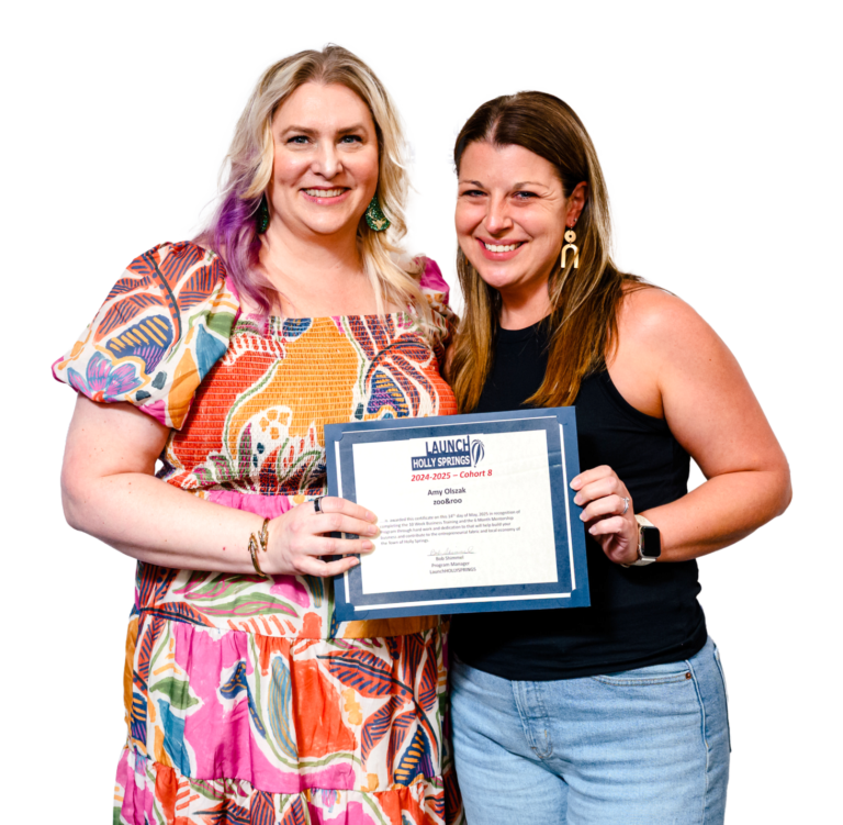 "Two women smiling, holding a certificate together, celebrating achievement.".